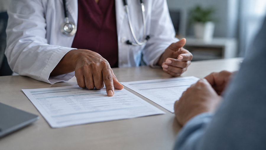 Clinician explaining two laboratory result pages