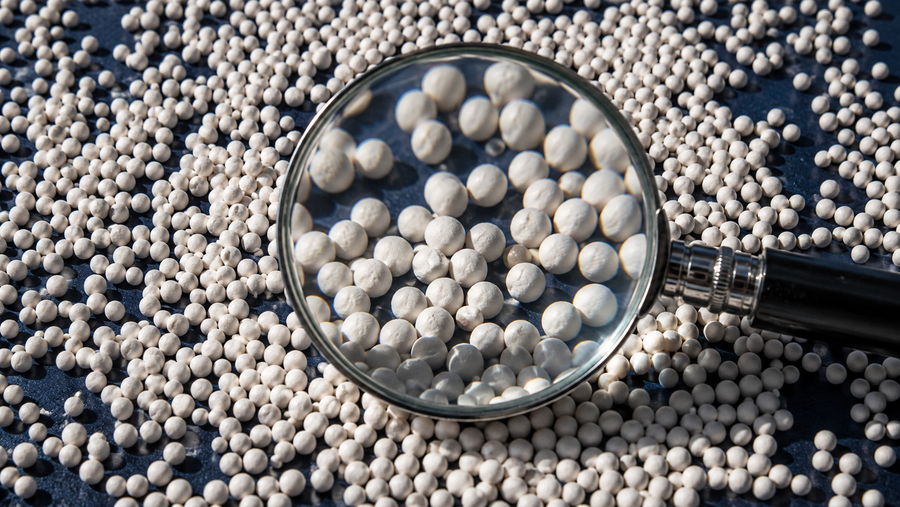 Magnifying glass over many small beads